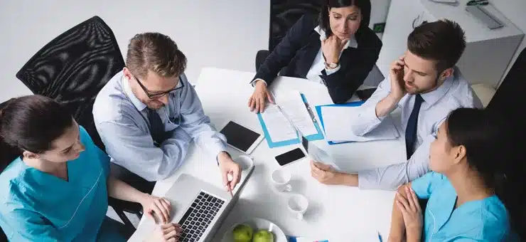 healthcare professionals collaborating to improve operations through outsourcing services - Nearbridge